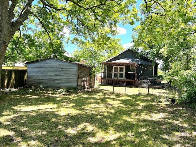 509 W Sears St, Denison, TX 75020 - view of yard with an outbuilding, a shed, and a deck