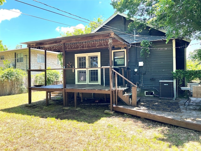 509 W Sears St, Denison, TX 75020 - back of house featuring cooling unit, a lawn, and a wooden deck