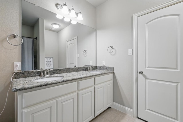 829 Milton Way, Coppell, TX 75019 - bathroom featuring double vanity, tile patterned flooring, and baseboards