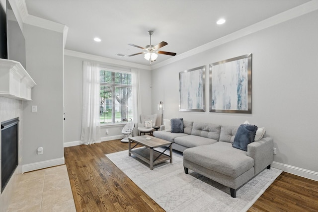 829 Milton Way, Coppell, TX 75019 - living room with a ceiling fan, crown molding, baseboards, a glass covered fireplace, and wood finished floors