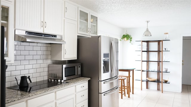 7640 Skylake Dr, Fort Worth, TX 76179 - kitchen featuring under cabinet range hood, stainless steel appliances, decorative backsplash, white cabinets, and a textured ceiling