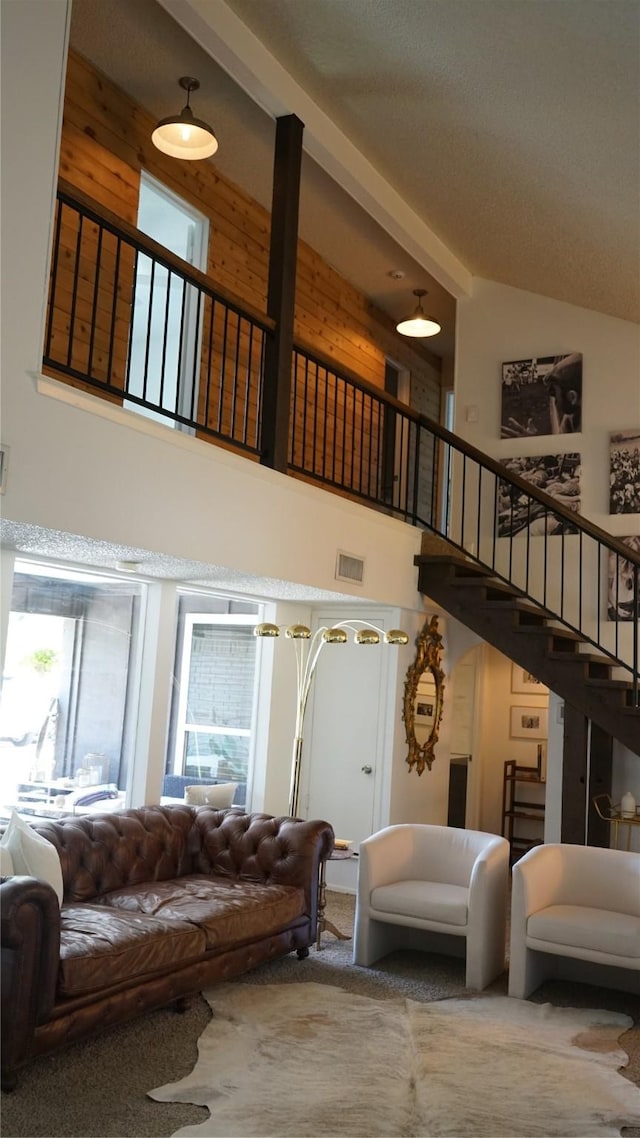 7640 Skylake Dr, Fort Worth, TX 76179 - carpeted living area featuring high vaulted ceiling and stairway