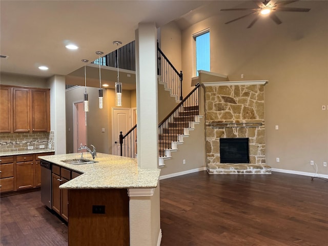 3400 Glen Crest Ln, Denton, TX 76208 - kitchen featuring a sink, stainless steel dishwasher, a ceiling fan, dark wood finished floors, and brown cabinetry