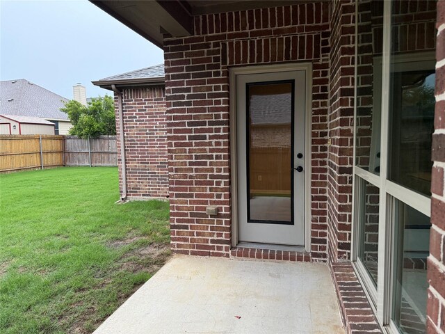 3400 Glen Crest Ln, Denton, TX 76208 - doorway to property featuring brick siding and a patio