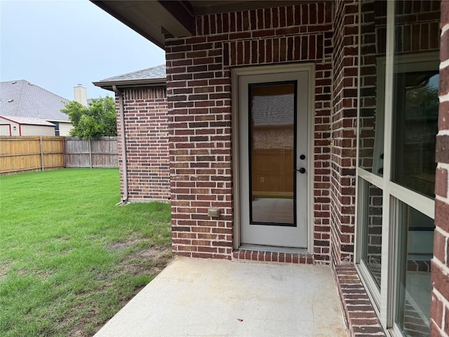3400 Glen Crest Ln, Denton, TX 76208 - view of exterior entry featuring brick siding and a patio area