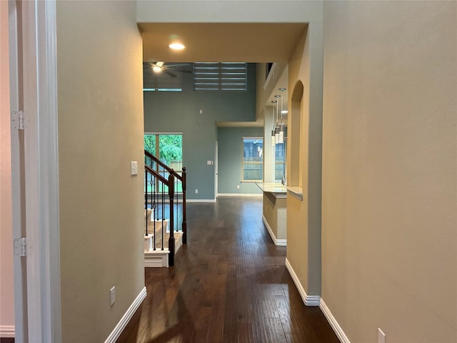 3400 Glen Crest Ln, Denton, TX 76208 - hallway with dark wood-style floors, baseboards, stairway, and arched walkways