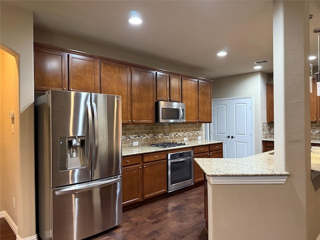 3400 Glen Crest Ln, Denton, TX 76208 - kitchen featuring stainless steel appliances, dark wood-style flooring, tasteful backsplash, light stone countertops, and recessed lighting