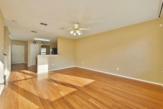 6917 Tessla Dr, Dallas, TX 75241 - unfurnished living room featuring wood finished floors, ceiling fan, and baseboards