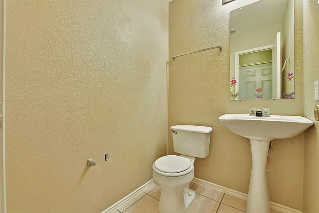 6917 Tessla Dr, Dallas, TX 75241 - bathroom featuring tile patterned flooring, toilet, and baseboards