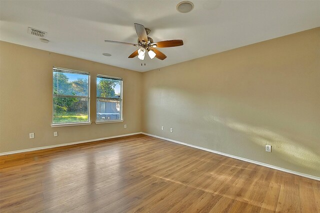 6917 Tessla Dr, Dallas, TX 75241 - unfurnished room with a ceiling fan, wood finished floors, and baseboards