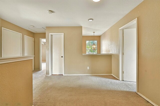 6917 Tessla Dr, Dallas, TX 75241 - carpeted empty room featuring baseboards, a smoke detector, and a textured wall