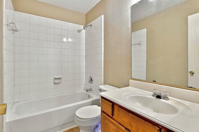 6917 Tessla Dr, Dallas, TX 75241 - full bathroom featuring toilet, vanity, bathing tub / shower combination, and a textured wall