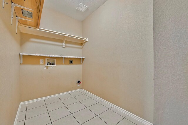 6917 Tessla Dr, Dallas, TX 75241 - washroom with hookup for an electric dryer, hookup for a washing machine, baseboards, and tile patterned floors