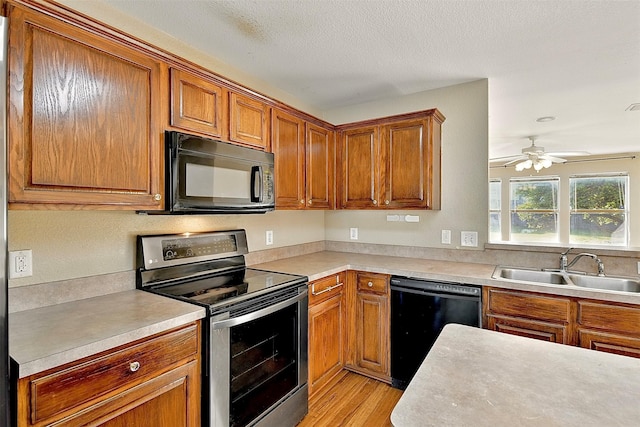 6917 Tessla Dr, Dallas, TX 75241 - kitchen featuring black appliances, a sink, ceiling fan, light countertops, and brown cabinetry