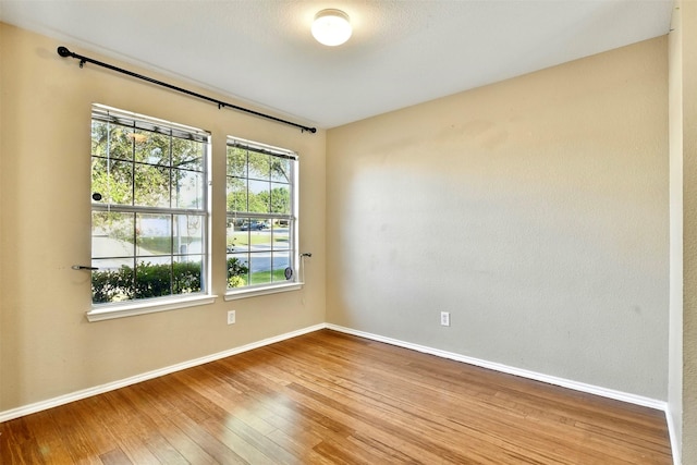 6917 Tessla Dr, Dallas, TX 75241 - spare room featuring hardwood / wood-style flooring and baseboards