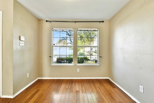 6917 Tessla Dr, Dallas, TX 75241 - empty room featuring hardwood / wood-style flooring, baseboards, and a textured wall