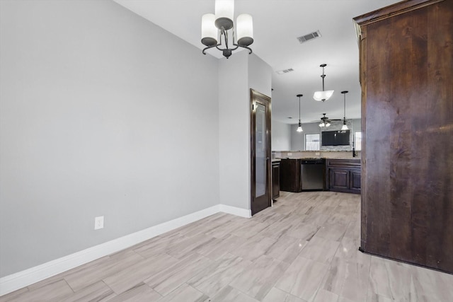 10825 Thorngrove Ct, Fort Worth, TX 76052 - kitchen with dishwashing machine, dark brown cabinetry, a chandelier, baseboards, and decorative light fixtures