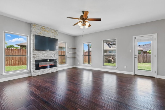 10825 Thorngrove Ct, Fort Worth, TX 76052 - unfurnished living room featuring ceiling fan, wood-type flooring, a stone fireplace, and baseboards