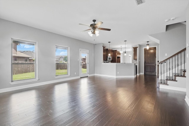 10825 Thorngrove Ct, Fort Worth, TX 76052 - unfurnished living room with a ceiling fan, baseboards, dark wood finished floors, and stairway