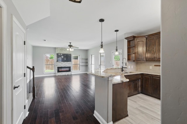 10825 Thorngrove Ct, Fort Worth, TX 76052 - kitchen with a sink, a peninsula, ceiling fan, open shelves, and decorative backsplash