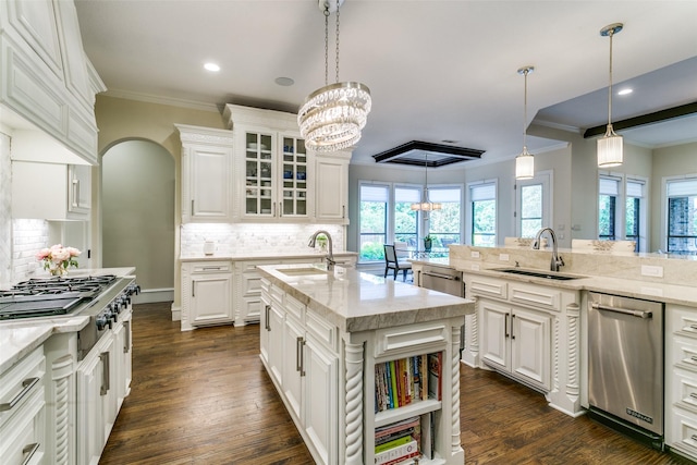 kitchen featuring a sink, ornamental molding, stainless steel gas stovetop, white cabinets, and recessed lighting