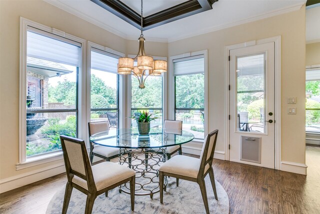dining room with a chandelier, crown molding, wood finished floors, and baseboards