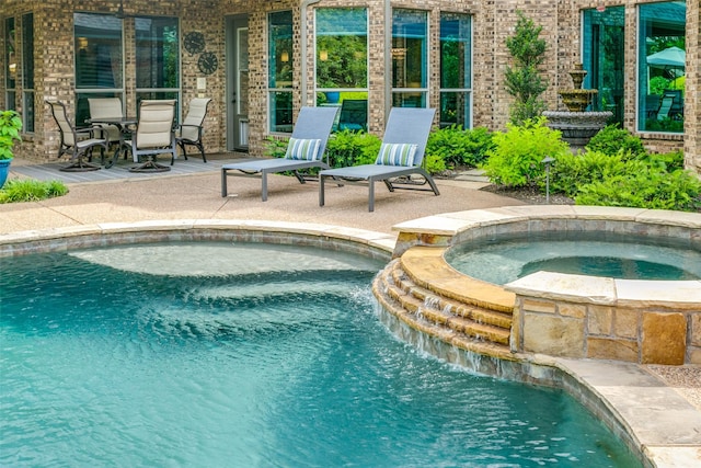 view of pool with a patio and a pool with connected hot tub