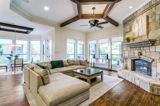living room featuring a ceiling fan, plenty of natural light, ornamental molding, dark wood-style floors, and coffered ceiling