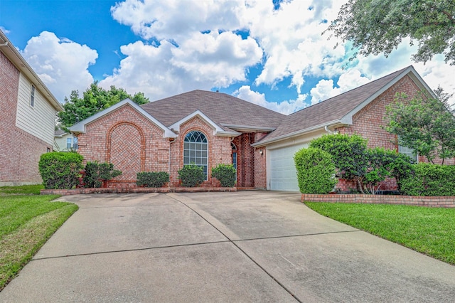 5316 Lake Mead Trl, Fort Worth, TX 76137 - view of front of home featuring brick siding, concrete driveway, a garage, a shingled roof, and a front lawn