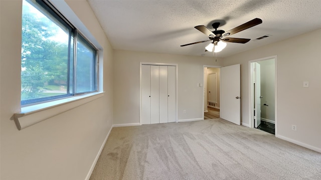 108 Meadowcrest Dr, Desoto, TX 75115 - unfurnished bedroom with multiple windows, baseboards, carpet, a closet, and a textured ceiling