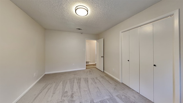 108 Meadowcrest Dr, Desoto, TX 75115 - unfurnished bedroom featuring a textured ceiling, carpet, baseboards, and a closet