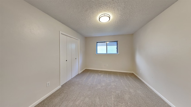 108 Meadowcrest Dr, Desoto, TX 75115 - unfurnished bedroom with a textured ceiling, carpet floors, baseboards, and a closet