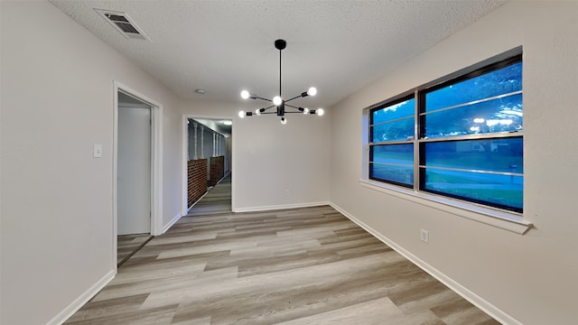 108 Meadowcrest Dr, Desoto, TX 75115 - unfurnished dining area featuring a chandelier, a textured ceiling, wood finished floors, and baseboards