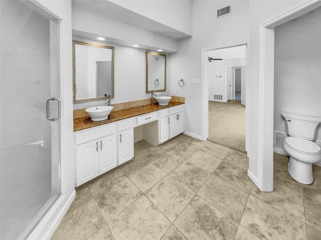 2303 Ox Bow Ct, Arlington, TX 76006 - full bathroom with double vanity, a stall shower, toilet, baseboards, and ceiling fan