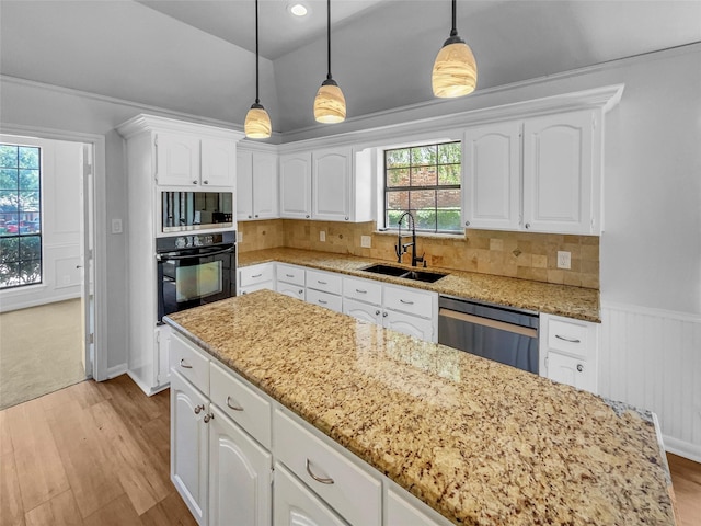 2303 Ox Bow Ct, Arlington, TX 76006 - kitchen with black oven, a sink, dishwashing machine, light wood-style flooring, and vaulted ceiling