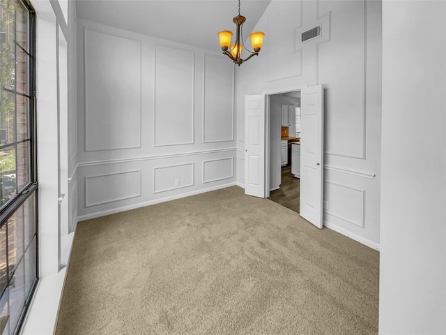 2303 Ox Bow Ct, Arlington, TX 76006 - unfurnished dining area with a decorative wall, a chandelier, carpet flooring, and a towering ceiling