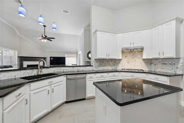kitchen with appliances with stainless steel finishes, a sink, a ceiling fan, decorative backsplash, and lofted ceiling