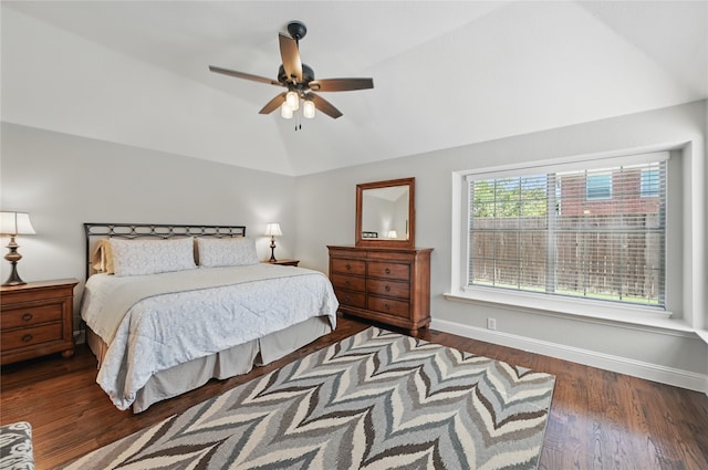 bedroom featuring lofted ceiling, wood finished floors, baseboards, and a ceiling fan