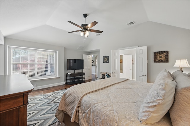 bedroom featuring vaulted ceiling, dark wood-type flooring, baseboards, and a ceiling fan