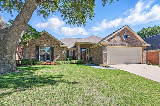 view of front facade featuring a garage, concrete driveway, a front yard, and brick siding