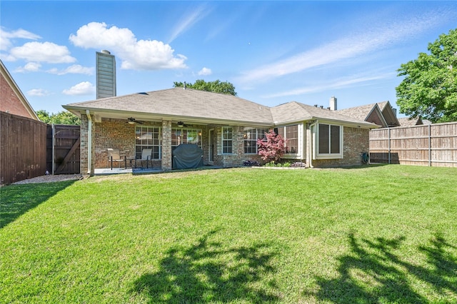 back of house featuring ceiling fan, a chimney, brick siding, and a patio