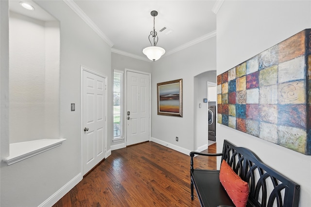 entryway featuring crown molding, baseboards, dark wood-style floors, arched walkways, and washer / clothes dryer