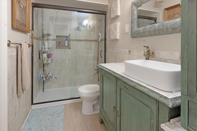 228 Mccarley Pl, Mckinney, TX 75071 - bathroom featuring tile walls, a shower stall, vanity, and toilet
