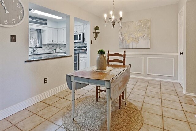 228 Mccarley Pl, Mckinney, TX 75071 - dining space with a chandelier, light tile patterned flooring, and baseboards