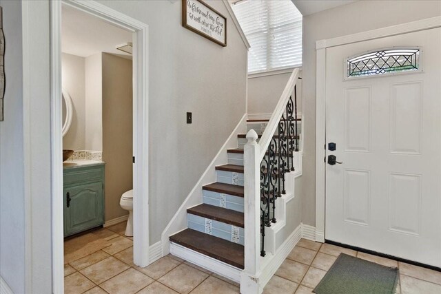 228 Mccarley Pl, Mckinney, TX 75071 - entrance foyer with stairs and light tile patterned floors