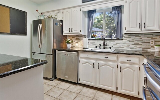 228 Mccarley Pl, Mckinney, TX 75071 - kitchen with stainless steel appliances, a sink, light tile patterned floors, backsplash, and white cabinets