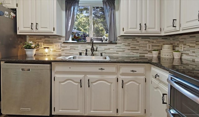 228 Mccarley Pl, Mckinney, TX 75071 - kitchen with stainless steel appliances, a sink, decorative backsplash, white cabinetry, and dark stone countertops