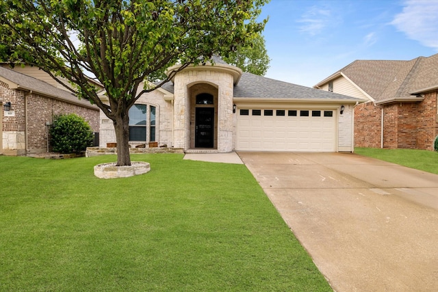 505 Osage Dr, Mckinney, TX 75071 - view of front of property with a garage, driveway, a front yard, stone siding, and a shingled roof