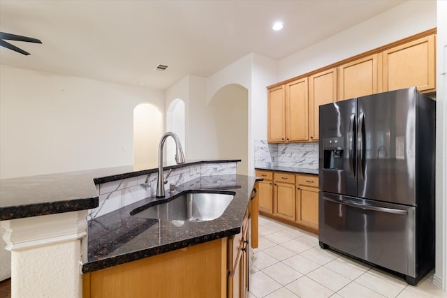 505 Osage Dr, Mckinney, TX 75071 - kitchen featuring refrigerator with ice dispenser, a sink, decorative backsplash, dark stone counters, and light tile patterned floors
