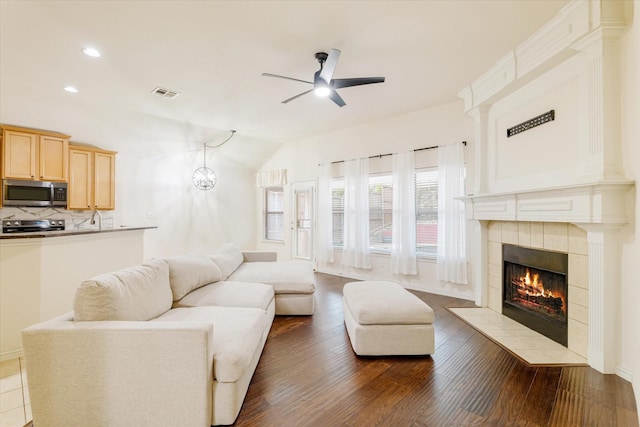 505 Osage Dr, Mckinney, TX 75071 - living area featuring ceiling fan, wood finished floors, vaulted ceiling, a tile fireplace, and recessed lighting
